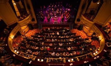Wide shot from above of audience and stage in a large auditorium