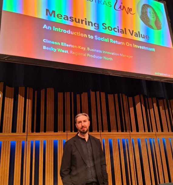 Cimeon standing in front of a projector screen