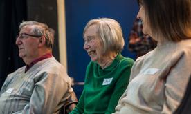 Close up of a man and two women, the woman central is smiling