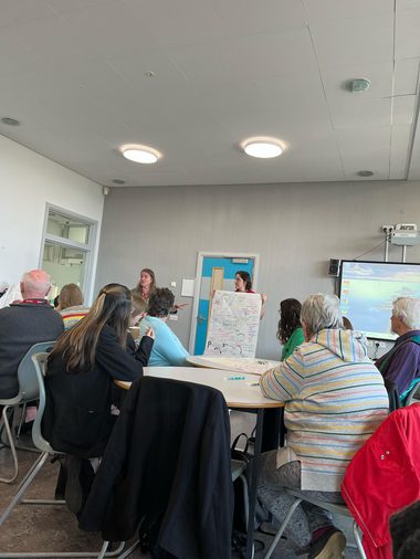 A group of people in a room making notes
