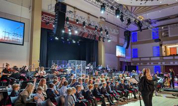 Group of school students performing on stage