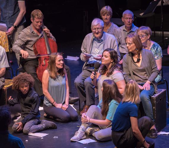 A group of women on stage with a cellist sat behind