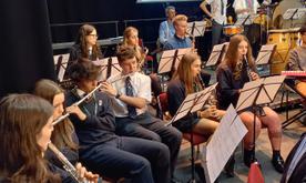 Group of students playing instruments performing