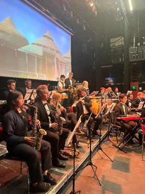 Side shot of musicians on stage playing instruments