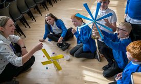 A group of primary school children playing with wind turbine models