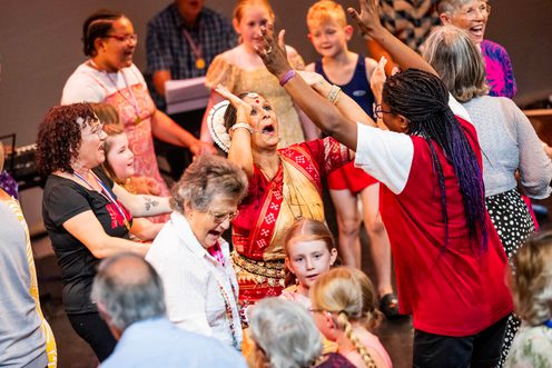 A diverse group of people dancing on stage