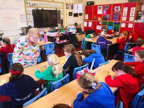 A classroom of students seated at tables