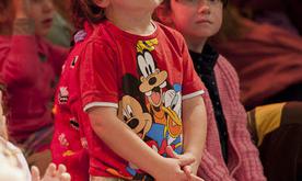A young boy looking up at the stage.