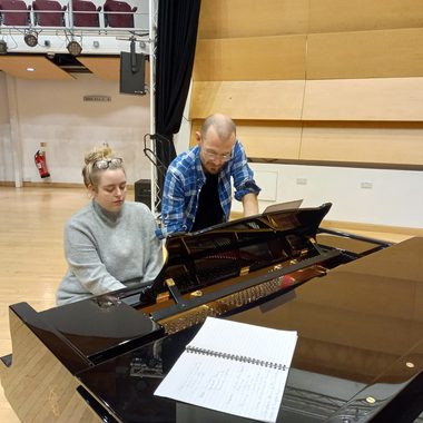 James and Chloe playing a piano together