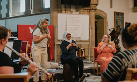Group of women sat in circle smiling