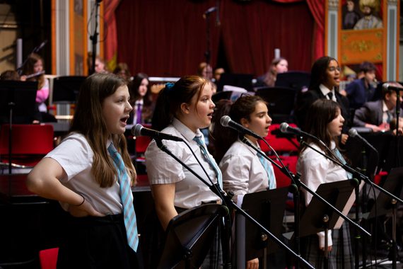 A group of young students sing together