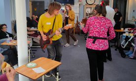 A group of people in a workshop dancing