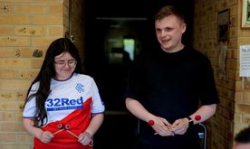 Two young people smile