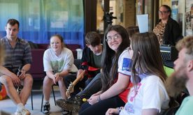 Young people in a workshop talk to one another
